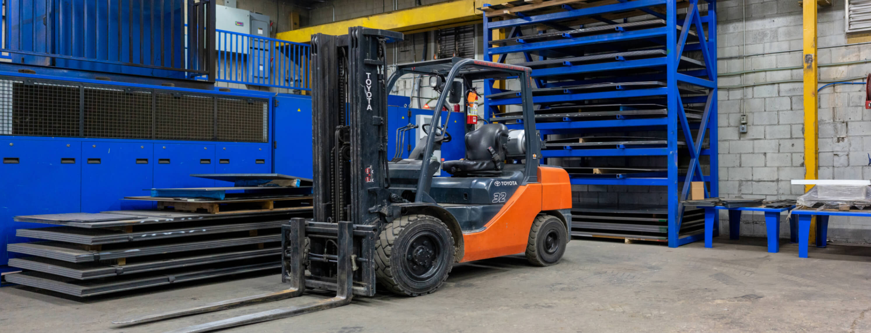 Laser cutting machine and forklift inside shop